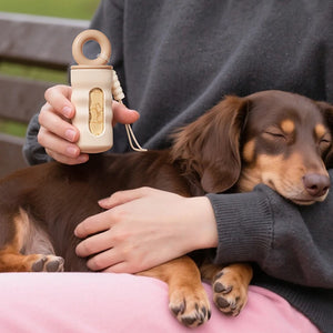 Twist-lock waste bag dispenser with leash attachment strap for dogs